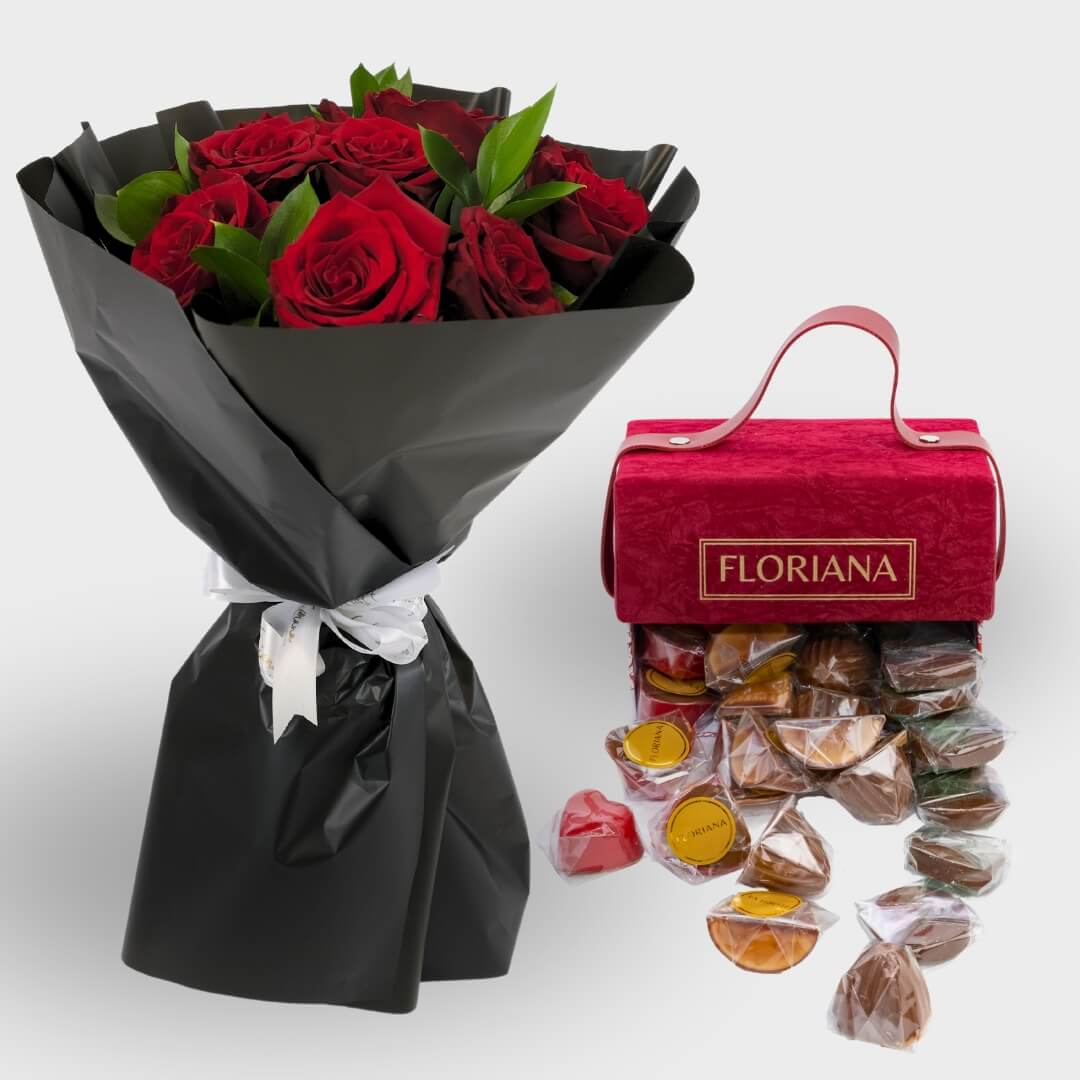 A bouquet of ten red roses wrapped in black paper with a velvet Floriana bag of red chocolates.